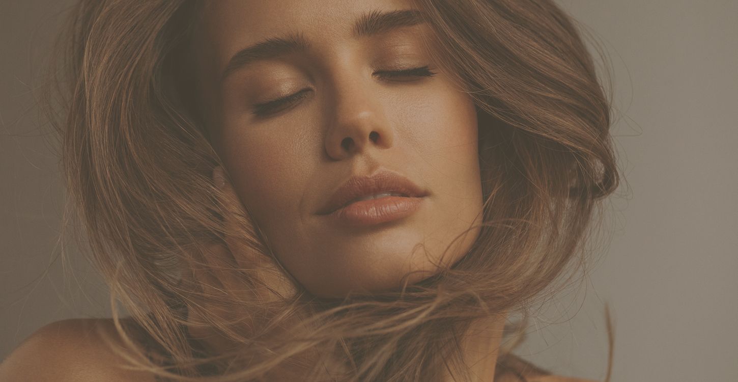 Woman with flowing hair and serene expression.