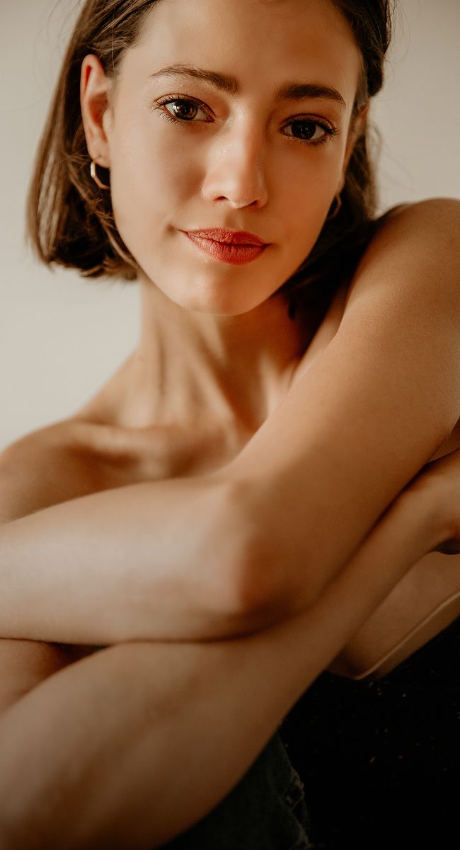 Young woman with short hair and soft expression.