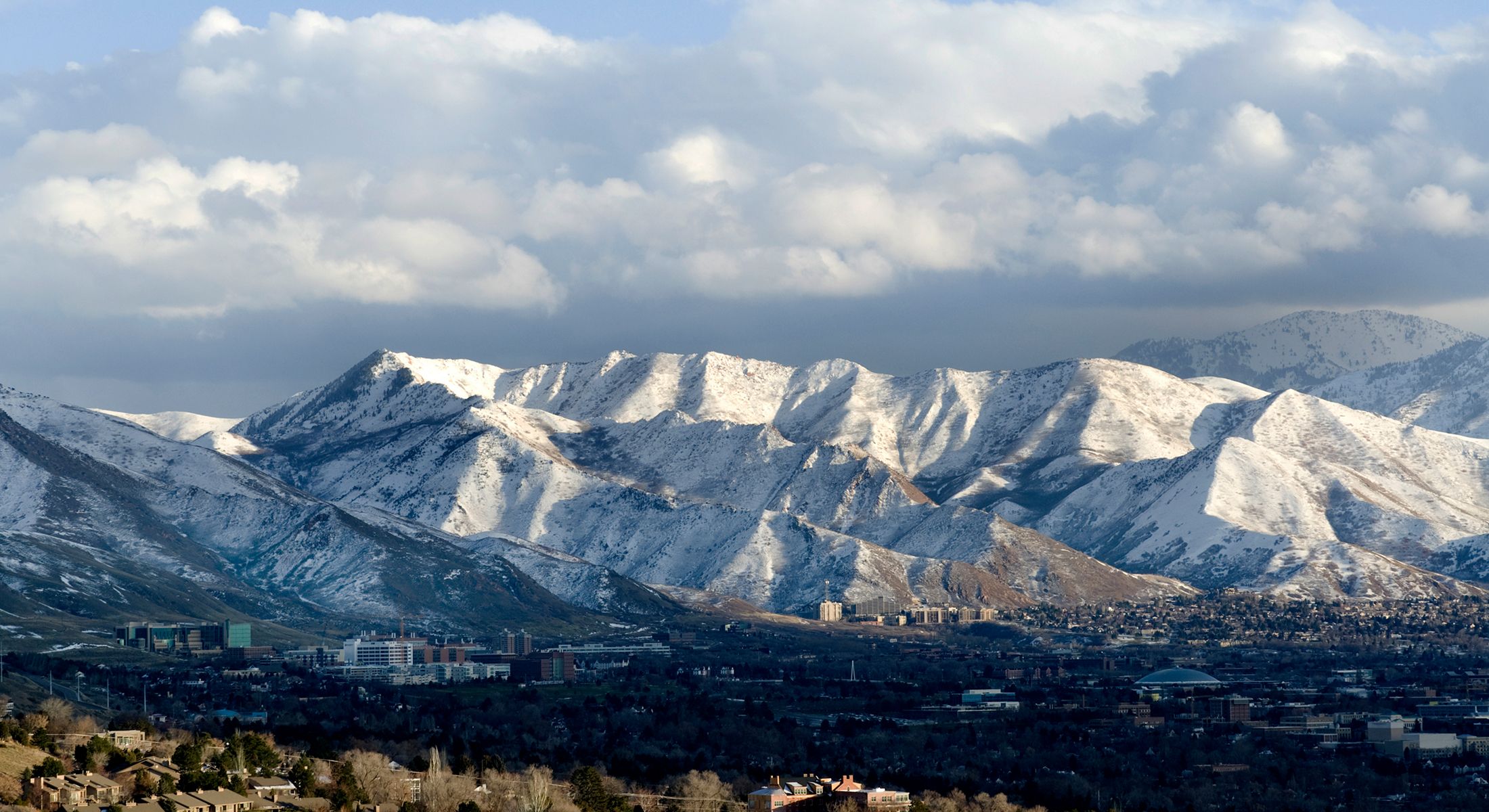 Snowy mountains under a cloudy sky.