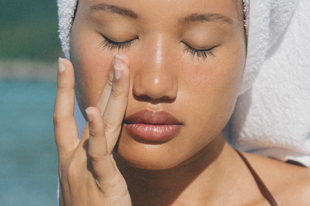 Woman applying sunscreen.